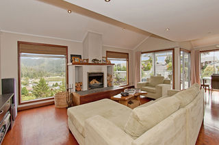 Jetmaster Built in Fire on raised riverstone hearth.